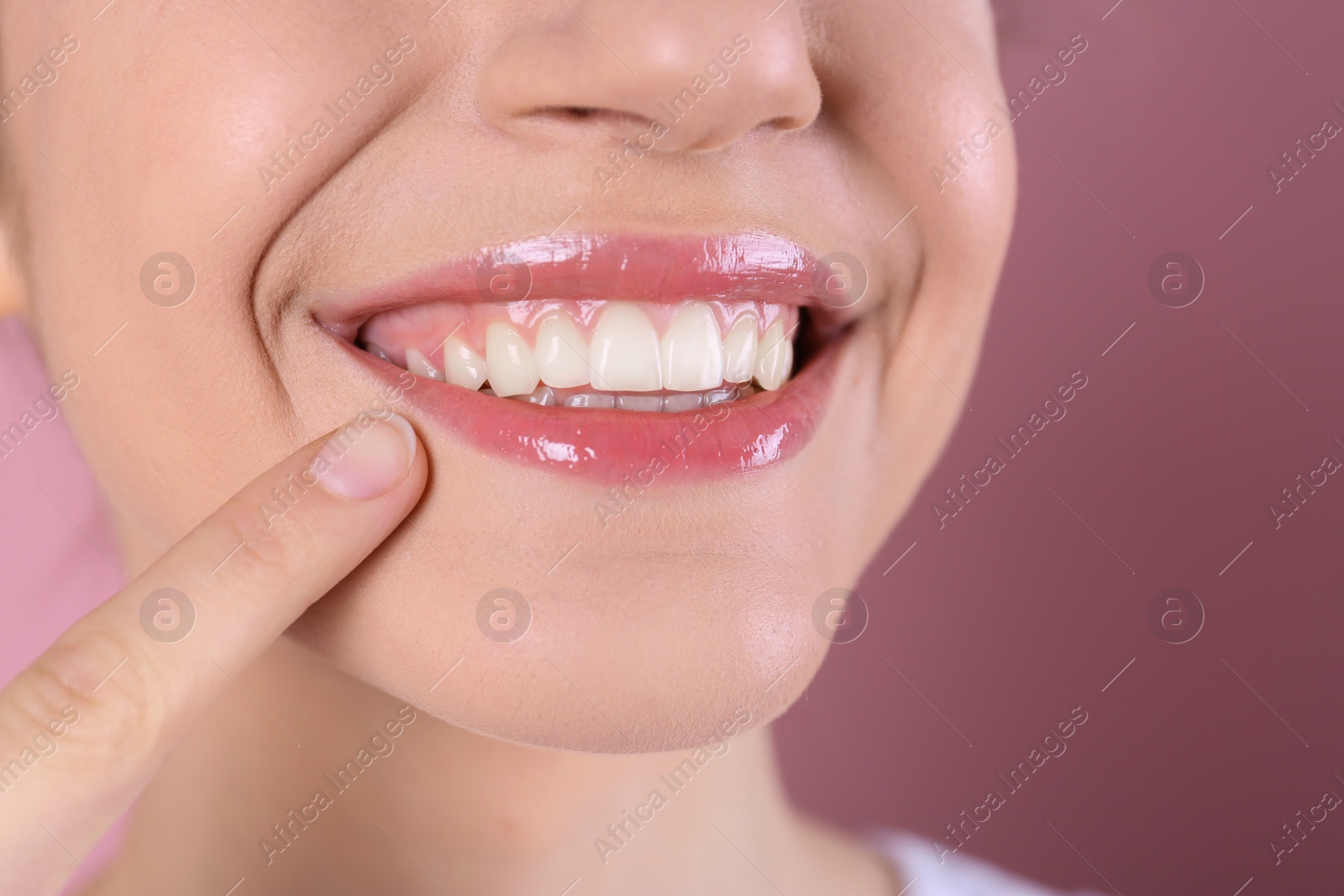 Photo of Young woman with healthy teeth and beautiful smile on color background, closeup