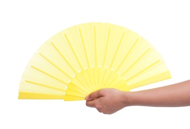 Woman holding yellow hand fan on white background, closeup