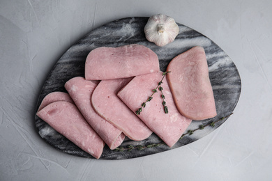 Photo of Tasty ham served on light grey table, top view