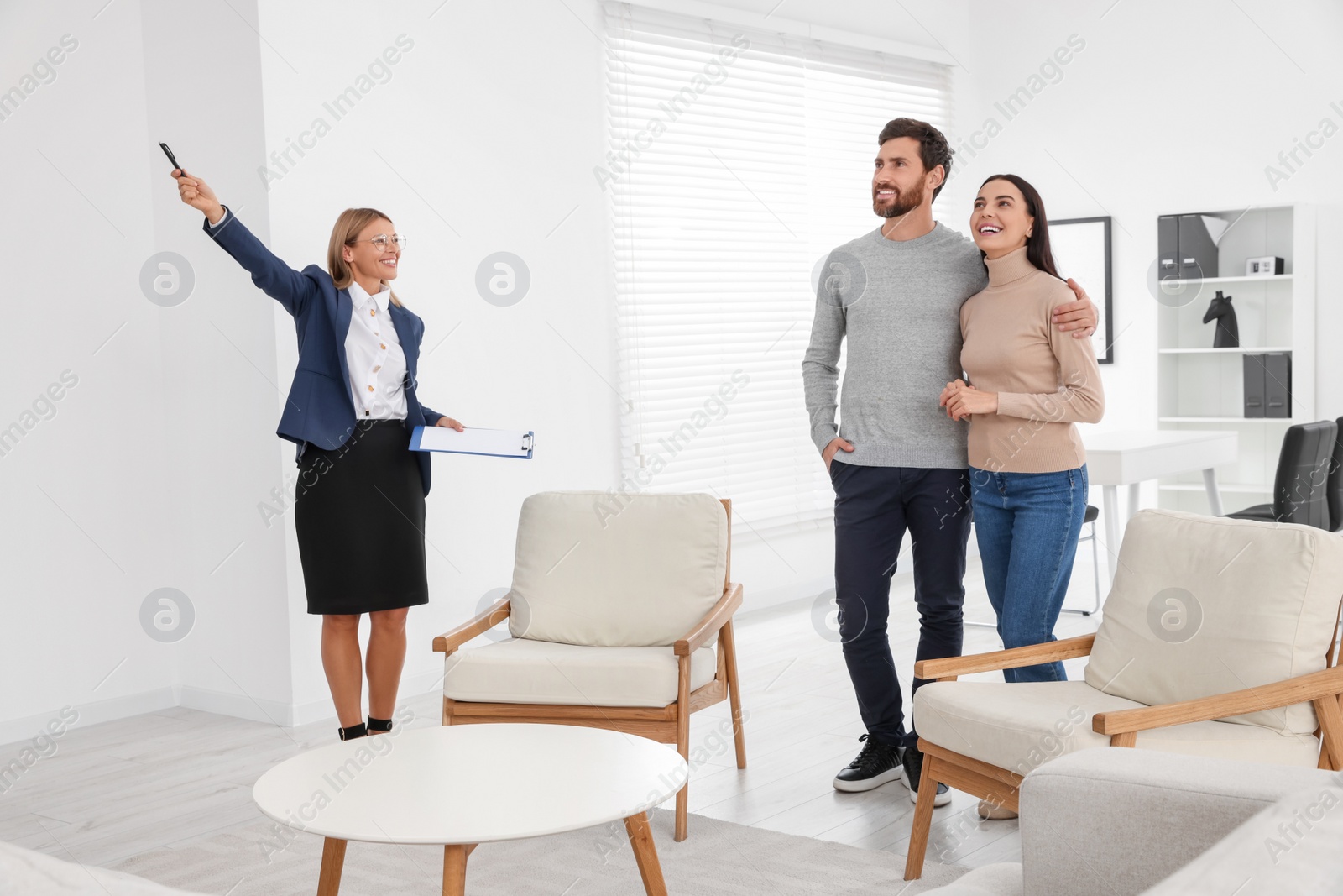 Photo of Real estate agent showing new apartment to couple