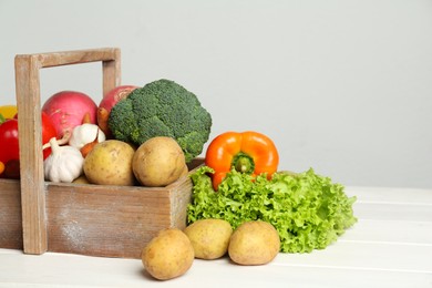 Photo of Assortment of fresh vegetables on white wooden table