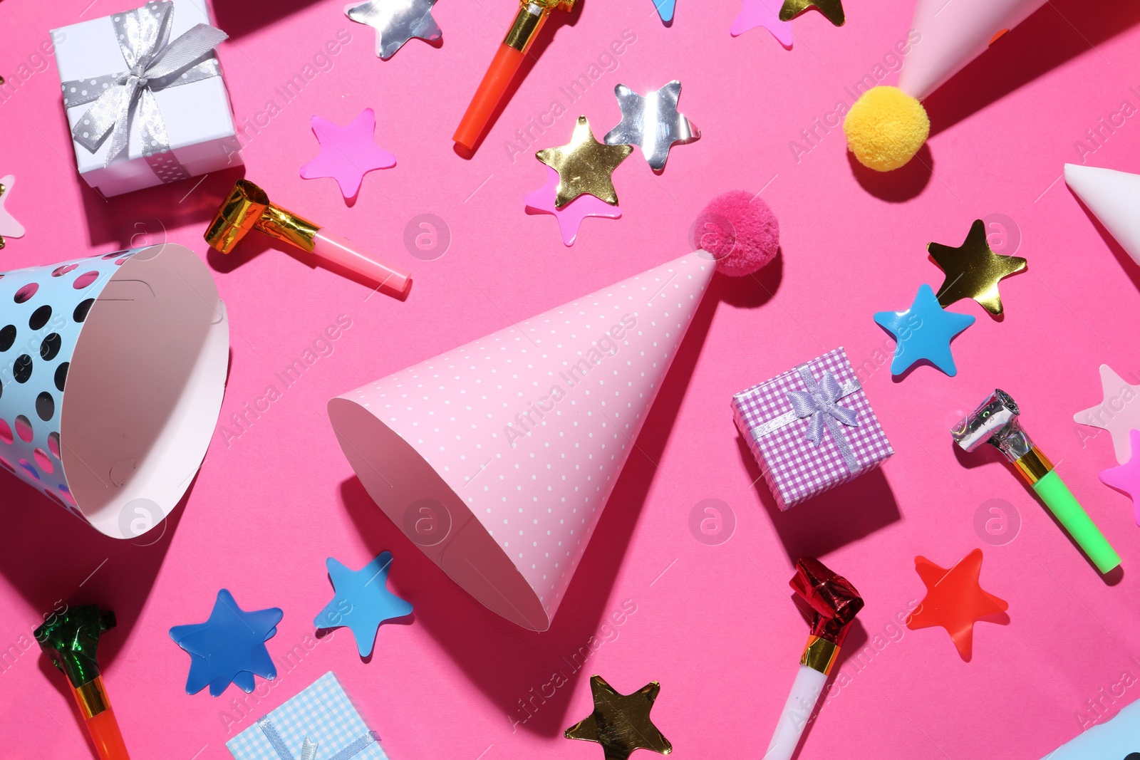 Photo of Flat lay composition with party hats on pink background