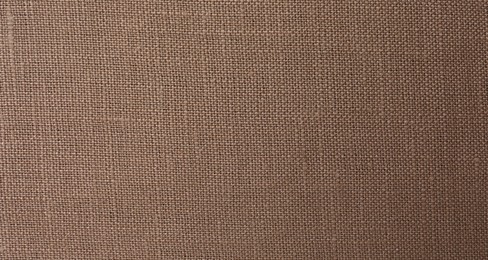 Photo of Texture of brown fabric as background, top view