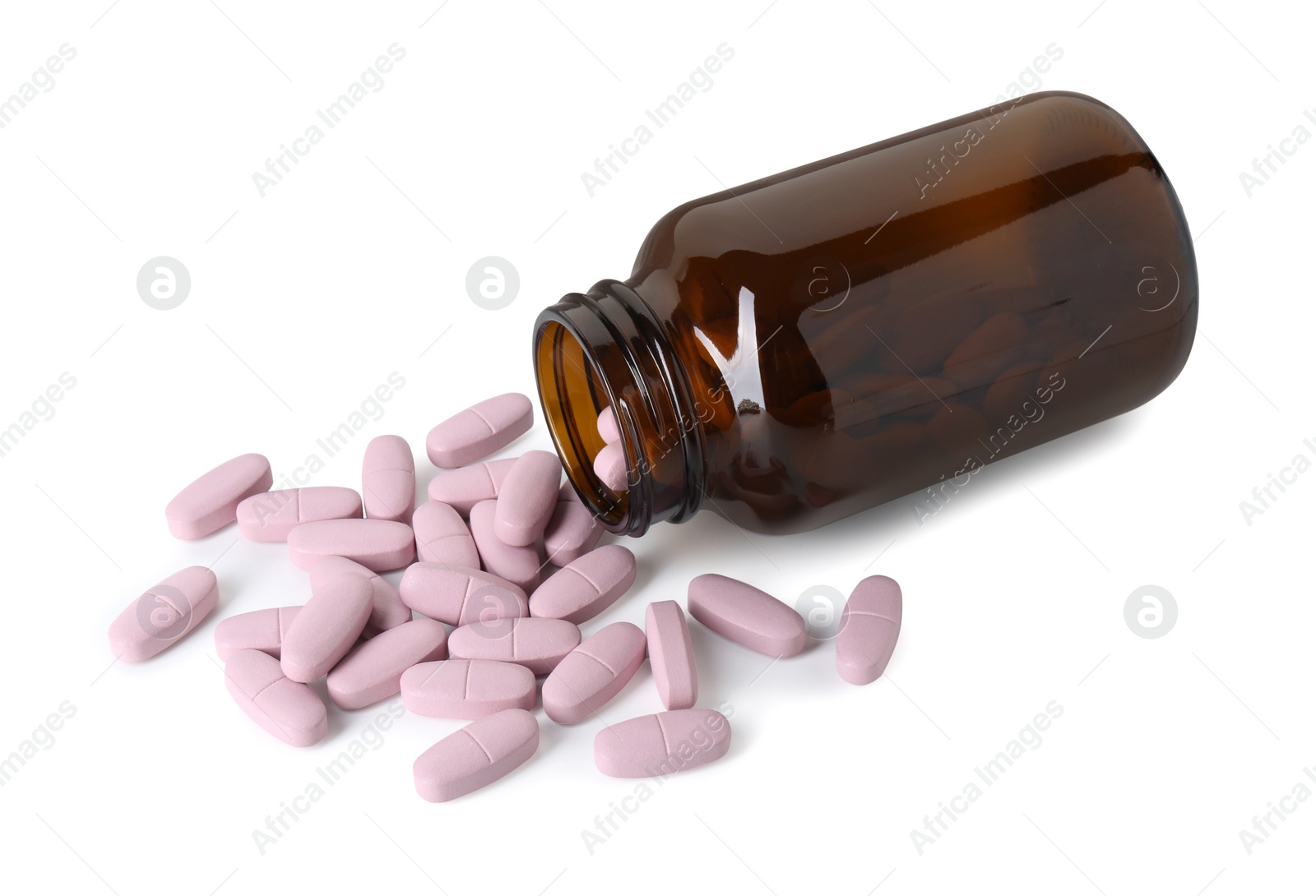 Photo of Scattered vitamin pills and bottle isolated on white