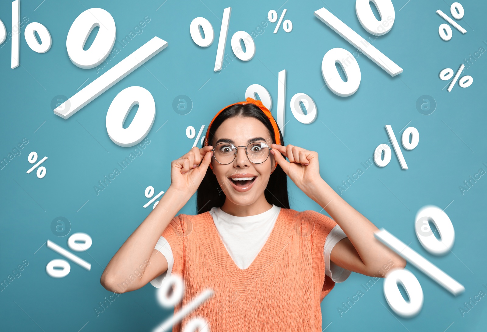 Image of Discount offer. Emotional woman on light blue background. Percent signs falling near her