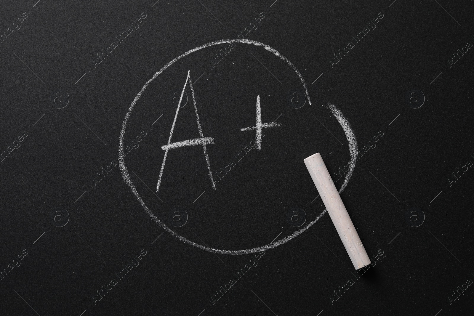 Photo of School grade. Letter A with plus symbol and chalk on blackboard, top view