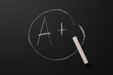 School grade. Letter A with plus symbol and chalk on blackboard, top view