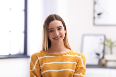 Photo of Portrait of happy teenage girl against blurred background