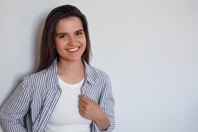 Portrait of beautiful young woman on white background, space for text