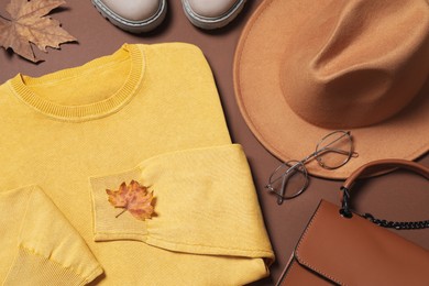 Flat lay composition with stylish hat on brown background