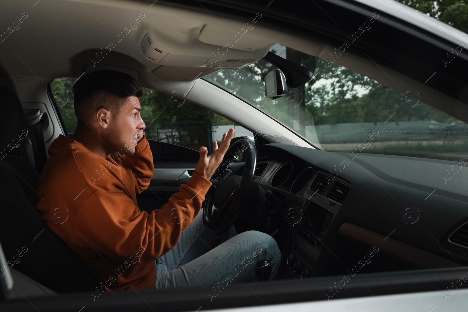 Photo of Stressed man in driver's seat of modern car