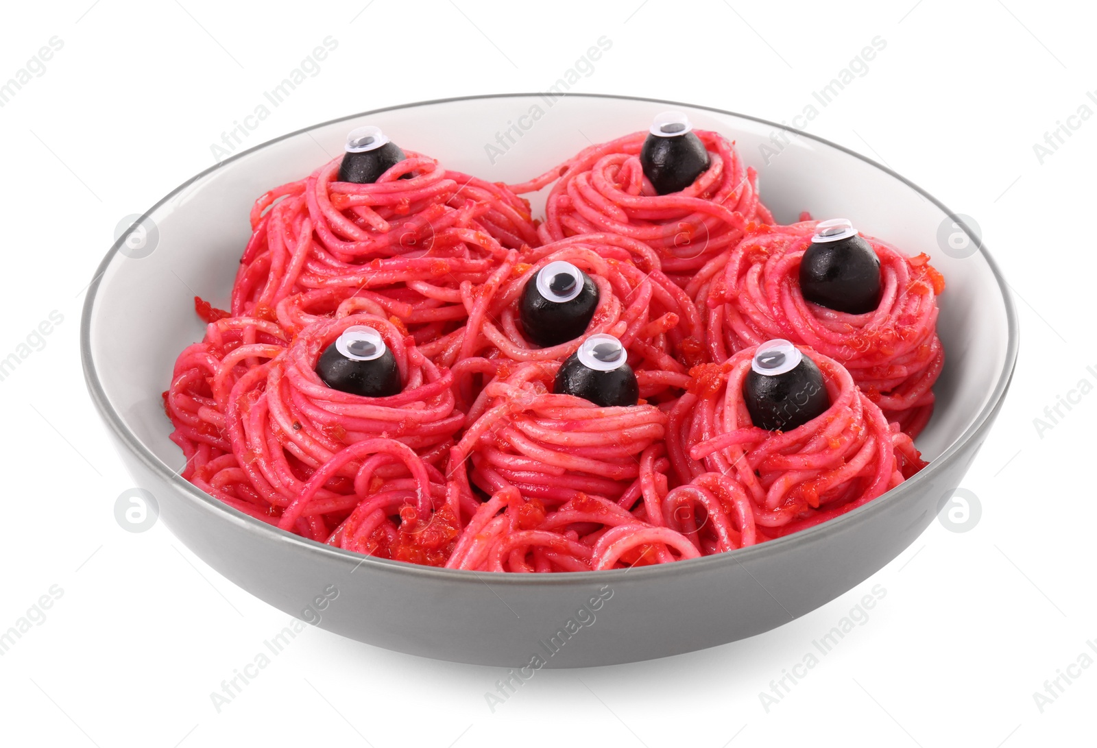 Photo of Red pasta with decorative eyes and olives in bowl isolated on white. Halloween food