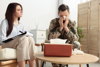 Psychologist working with military officer in office