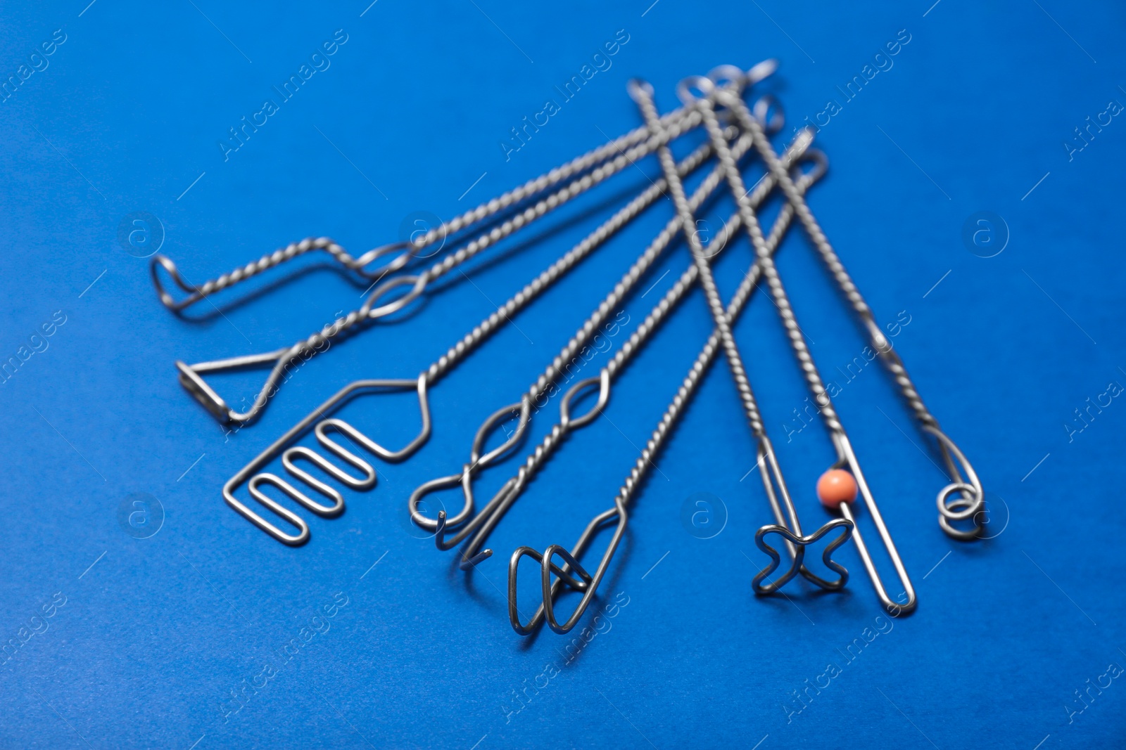 Photo of Set of logopedic probes for speech therapy on blue background