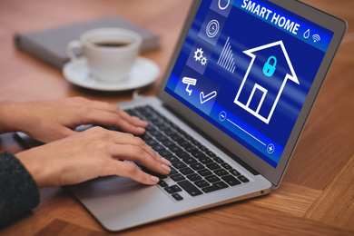 Image of Woman using home security app indoors, closeup