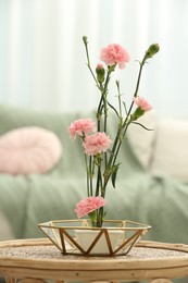 Photo of Ikebana art. Beautiful pink carnation flowers carrying cozy atmosphere at home