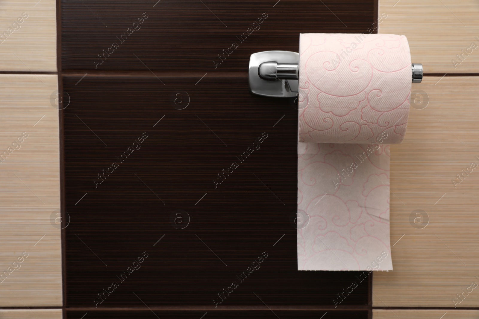 Photo of Holder with soft toilet paper roll in bathroom. Space for text