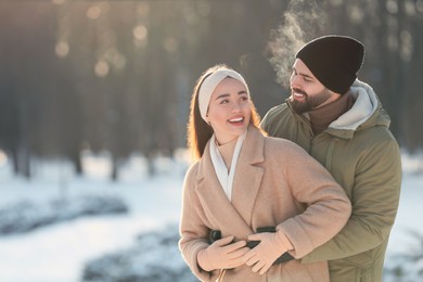 Beautiful young couple enjoying winter day outdoors