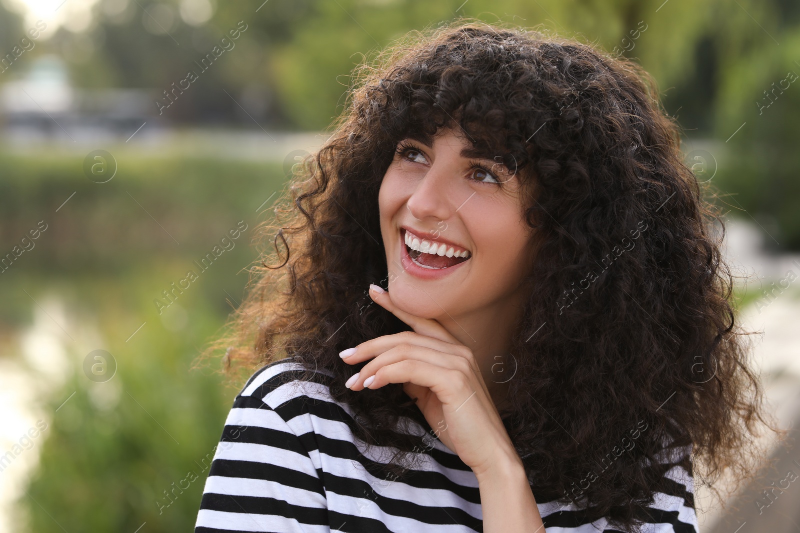 Photo of Portrait of beautiful woman outdoors. Attractive lady smiling and posing for camera