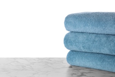 Fresh towels on marble table against white background. Space for text