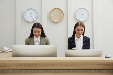 Photo of Beautiful receptionists working at counter in hotel