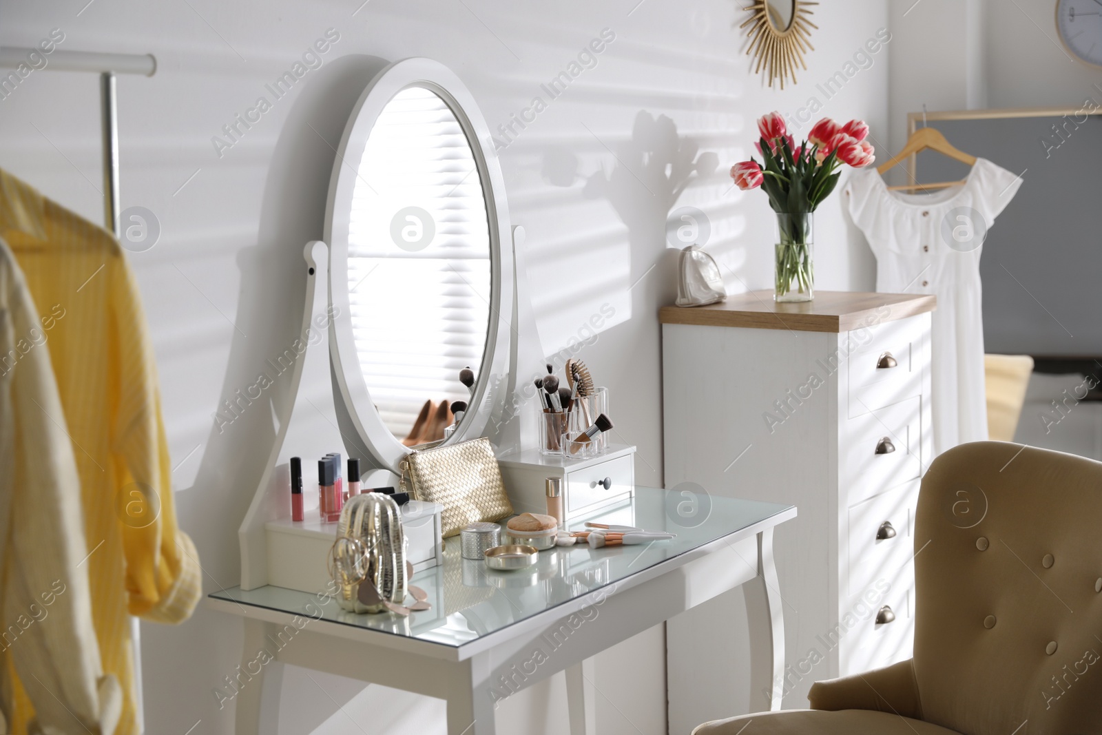 Photo of Stylish room interior with elegant dressing table and comfortable chair