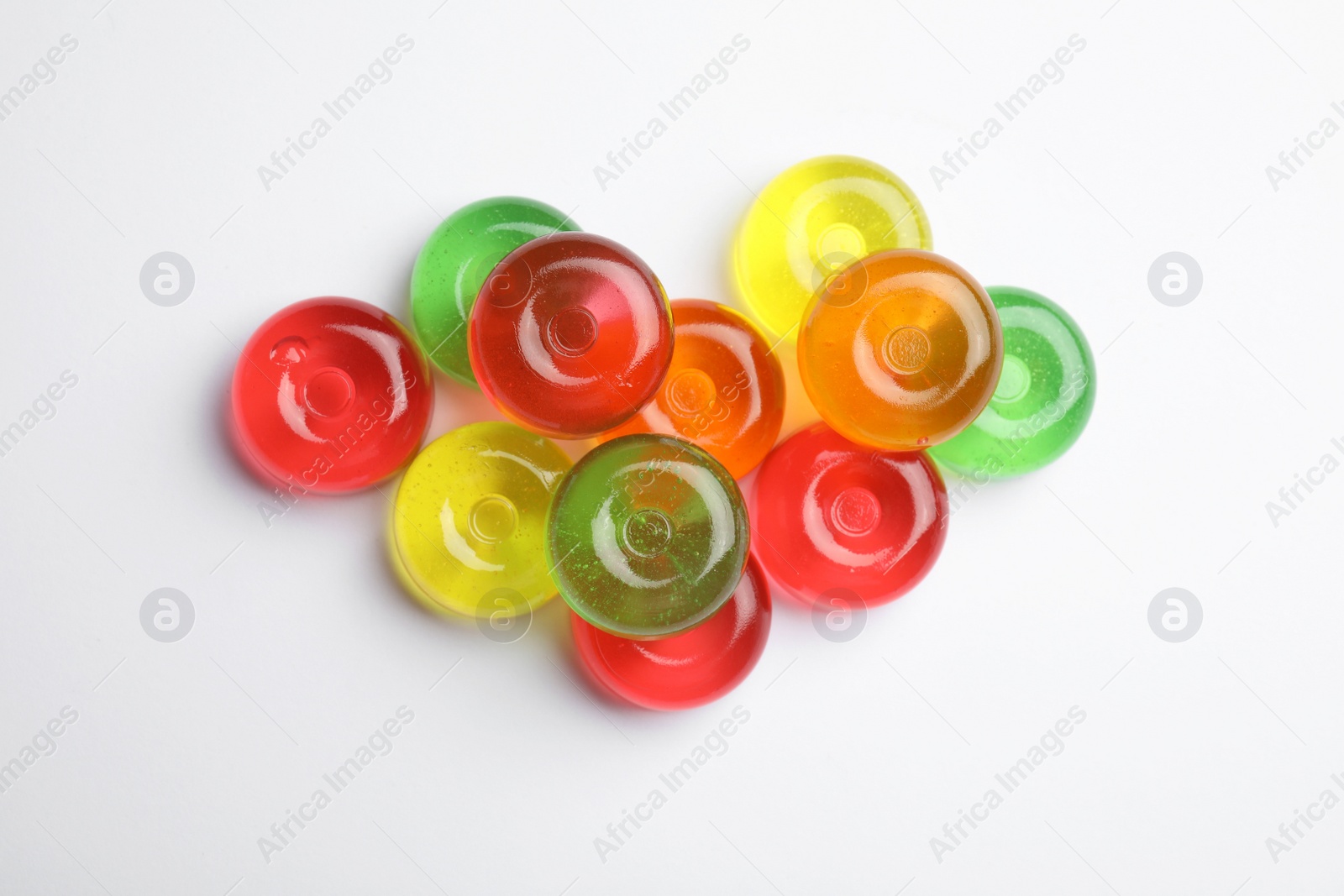 Photo of Delicious colorful candies on white background, top view