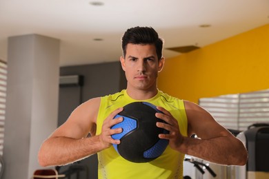 Photo of Muscular man with medicine ball in gym