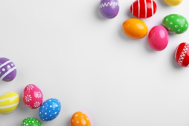 Decorated Easter eggs and space for text on white background, top view