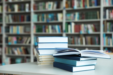 Photo of Stack of books on white table in library