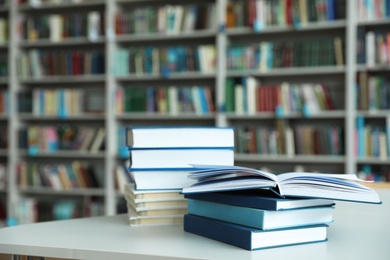 Stack of books on white table in library