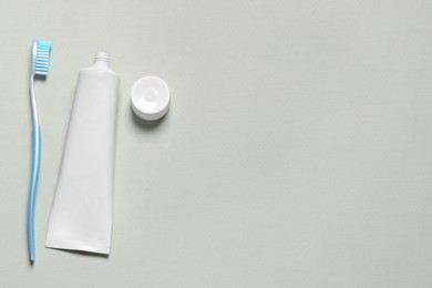 Photo of Plastic toothbrush and paste on white background, flat lay. Space for text