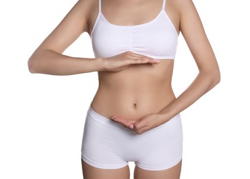 Woman in underwear holding something near her belly on white background, closeup. Healthy stomach