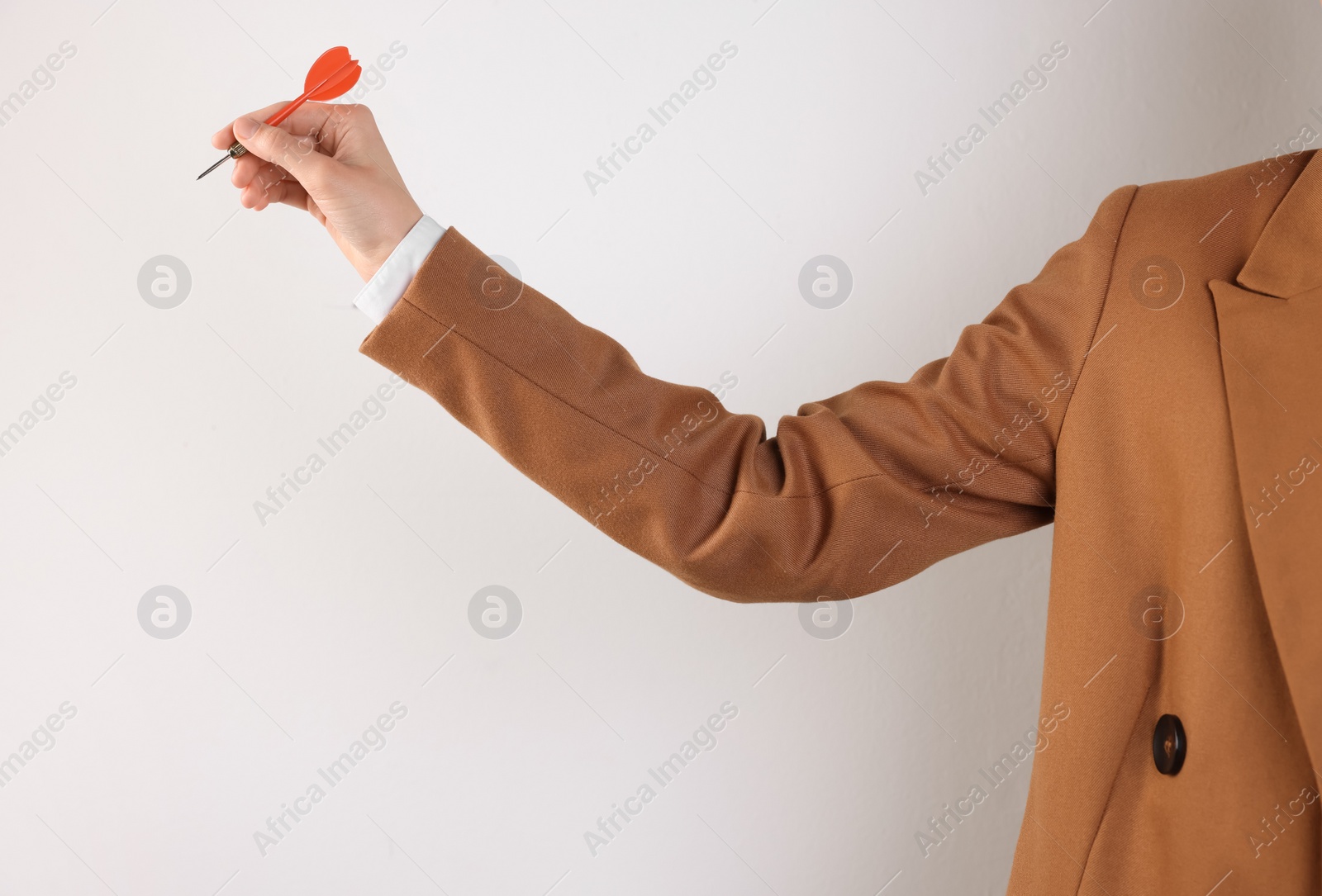 Photo of Businesswoman holding red dart on white background, closeup