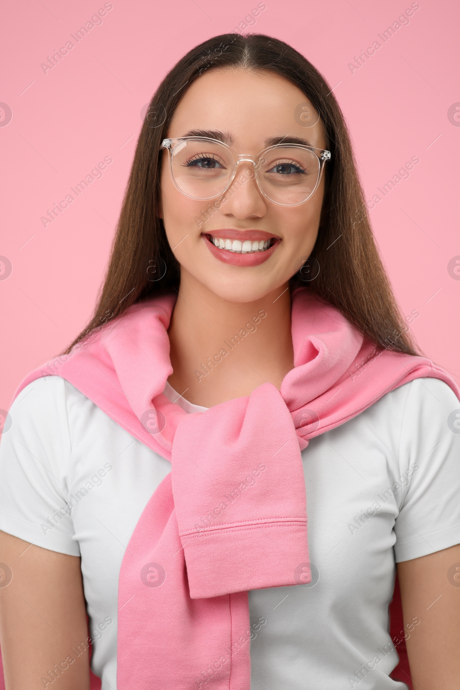 Photo of Happy woman wearing glasses on pink background