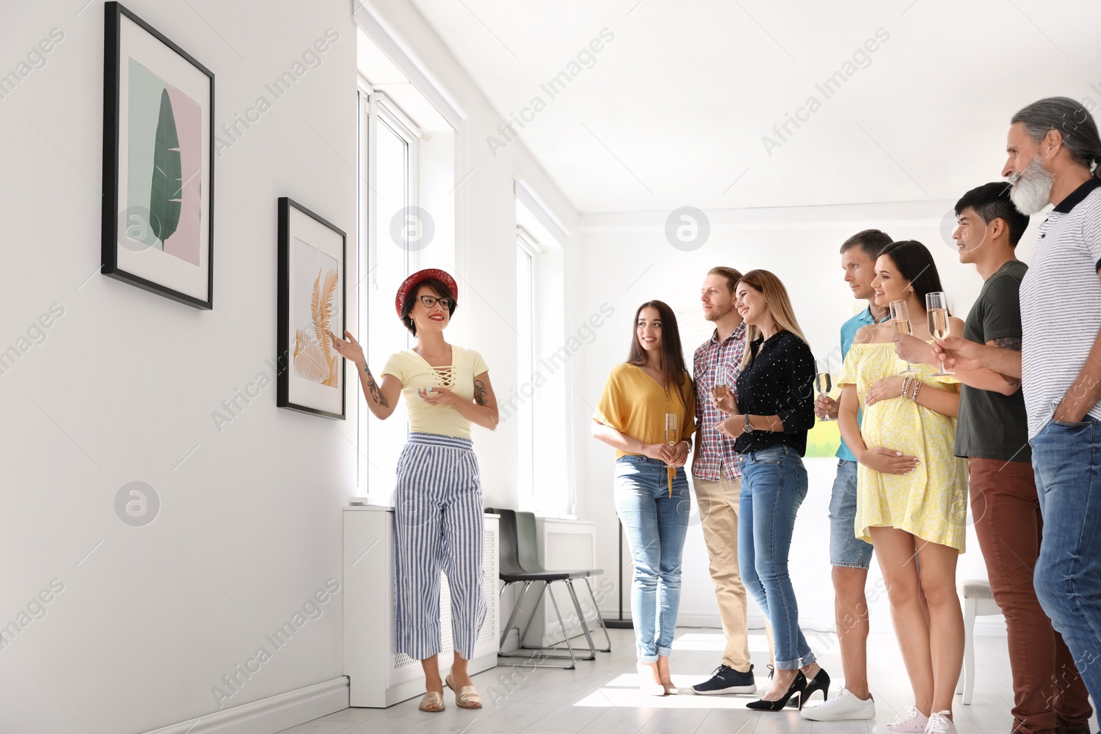 Photo of Group of people with guide at exhibition in art gallery