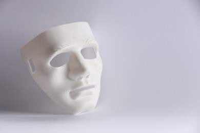 Plastic face mask on white background, space for text. Theatrical performance