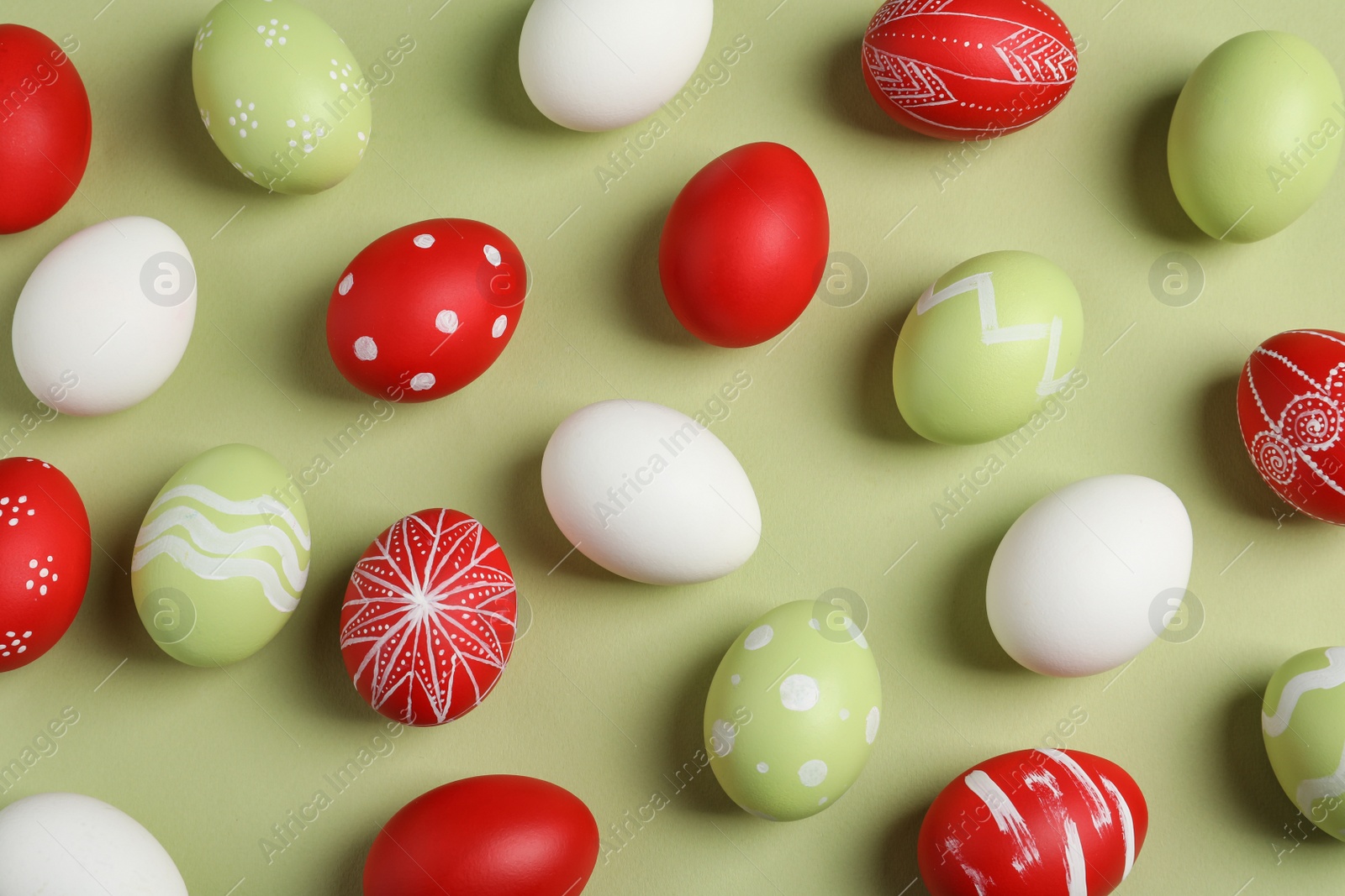 Photo of Flat lay composition of painted Easter eggs on color background