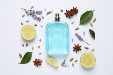 Photo of Composition with bottle of perfume and fresh citrus fruit on white background, top view