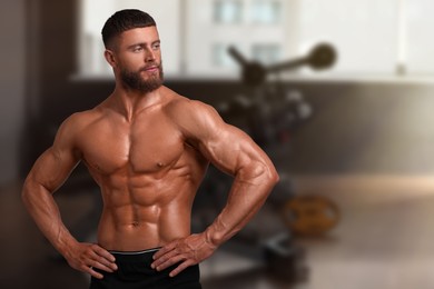Image of Handsome bodybuilder with muscular body in gym, space for text