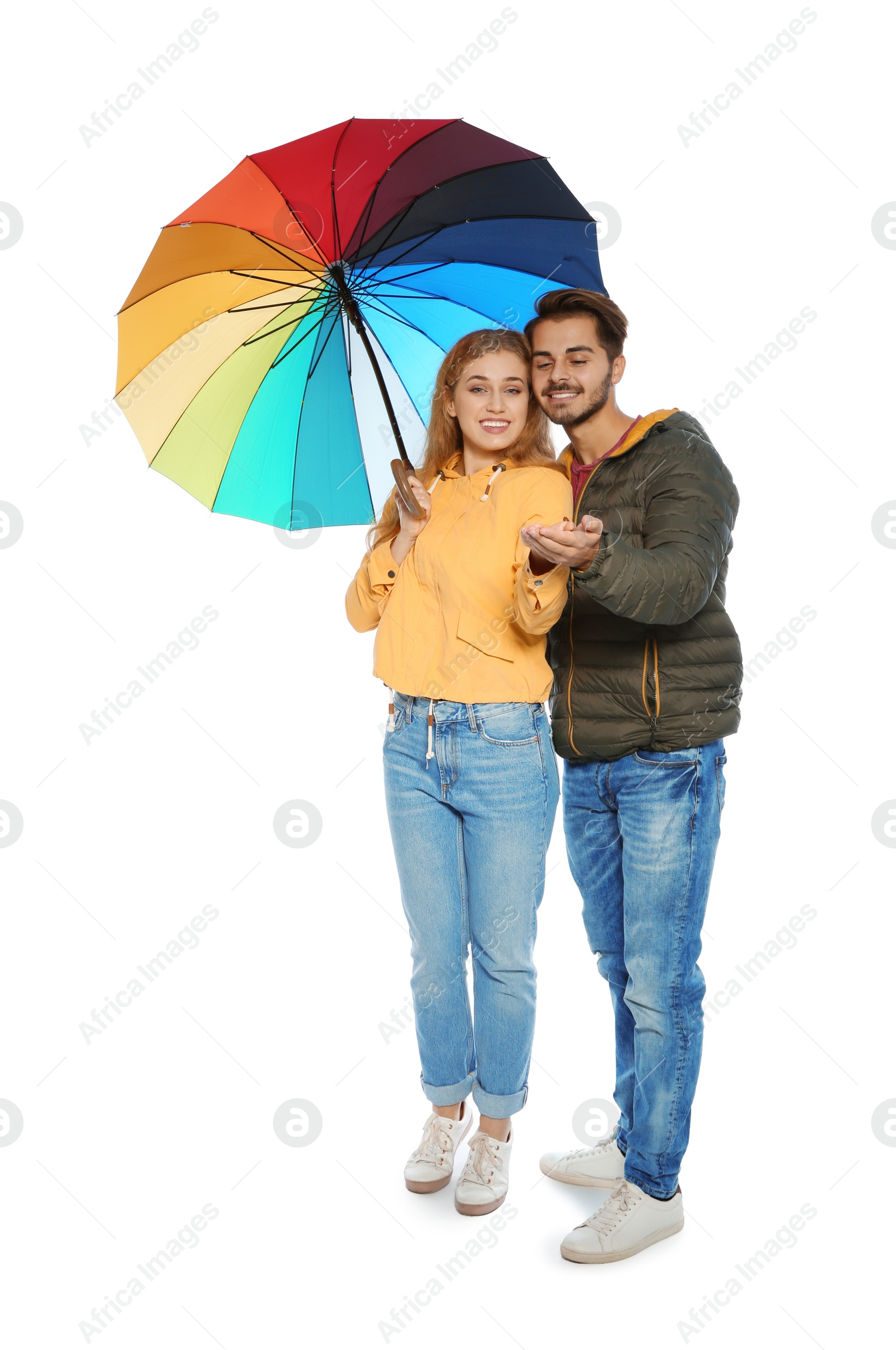 Photo of Young romantic couple with bright umbrella on white background