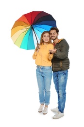 Photo of Young romantic couple with bright umbrella on white background