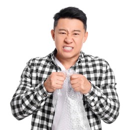 Emotional asian man with bubble wrap on white background