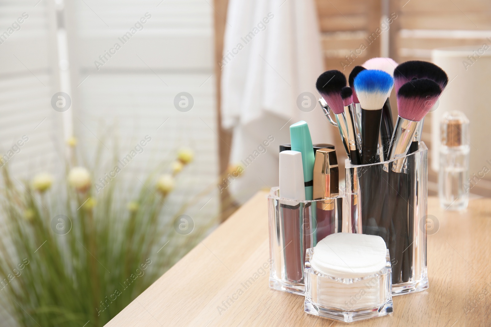 Photo of Organizer with makeup cosmetic products and space for text on dressing table