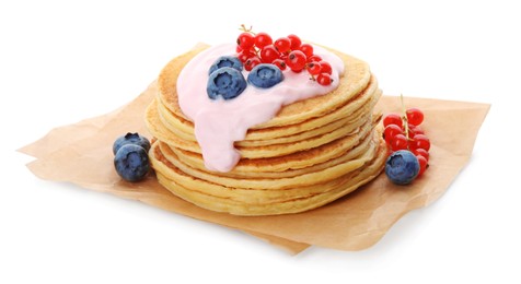 Tasty pancakes with natural yogurt, blueberries and red currants on white background