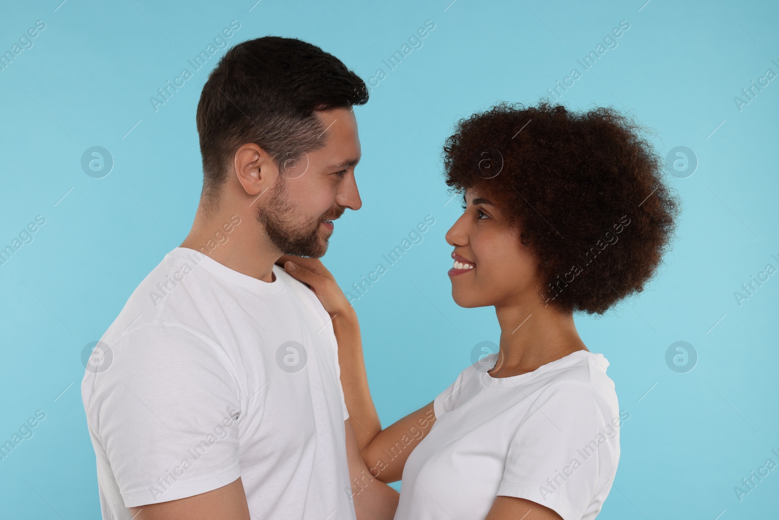 Photo of International dating. Portrait of happy couple on light blue background