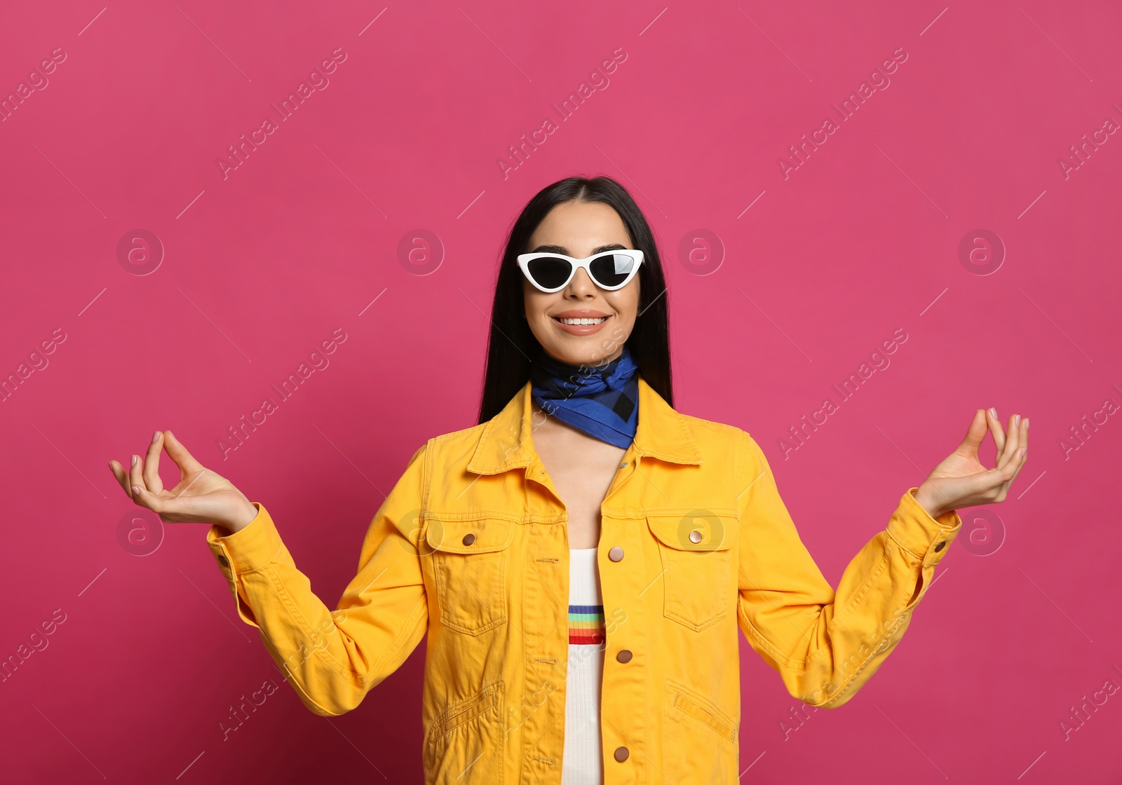 Photo of Fashionable young woman in stylish outfit with bandana on pink background