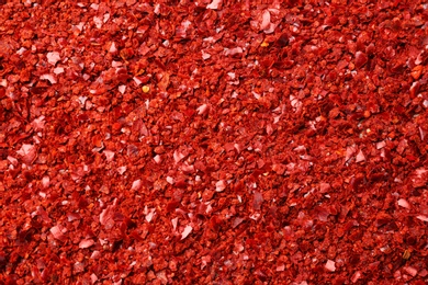 Photo of Chili pepper flakes as background, closeup
