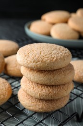 Photo of Delicious sugar cookies on cooling rack, closeup