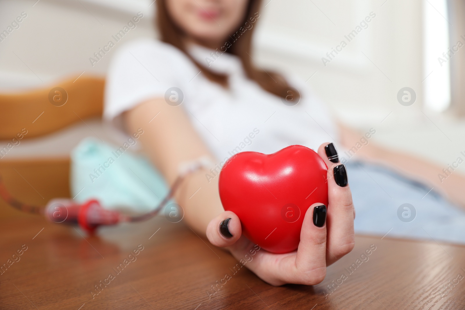 Photo of Teenager donating blood in hospital, closeup view